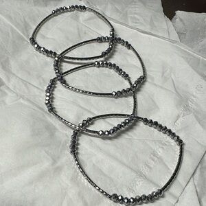 Set 4 of silver toned multi row stretch bracelet